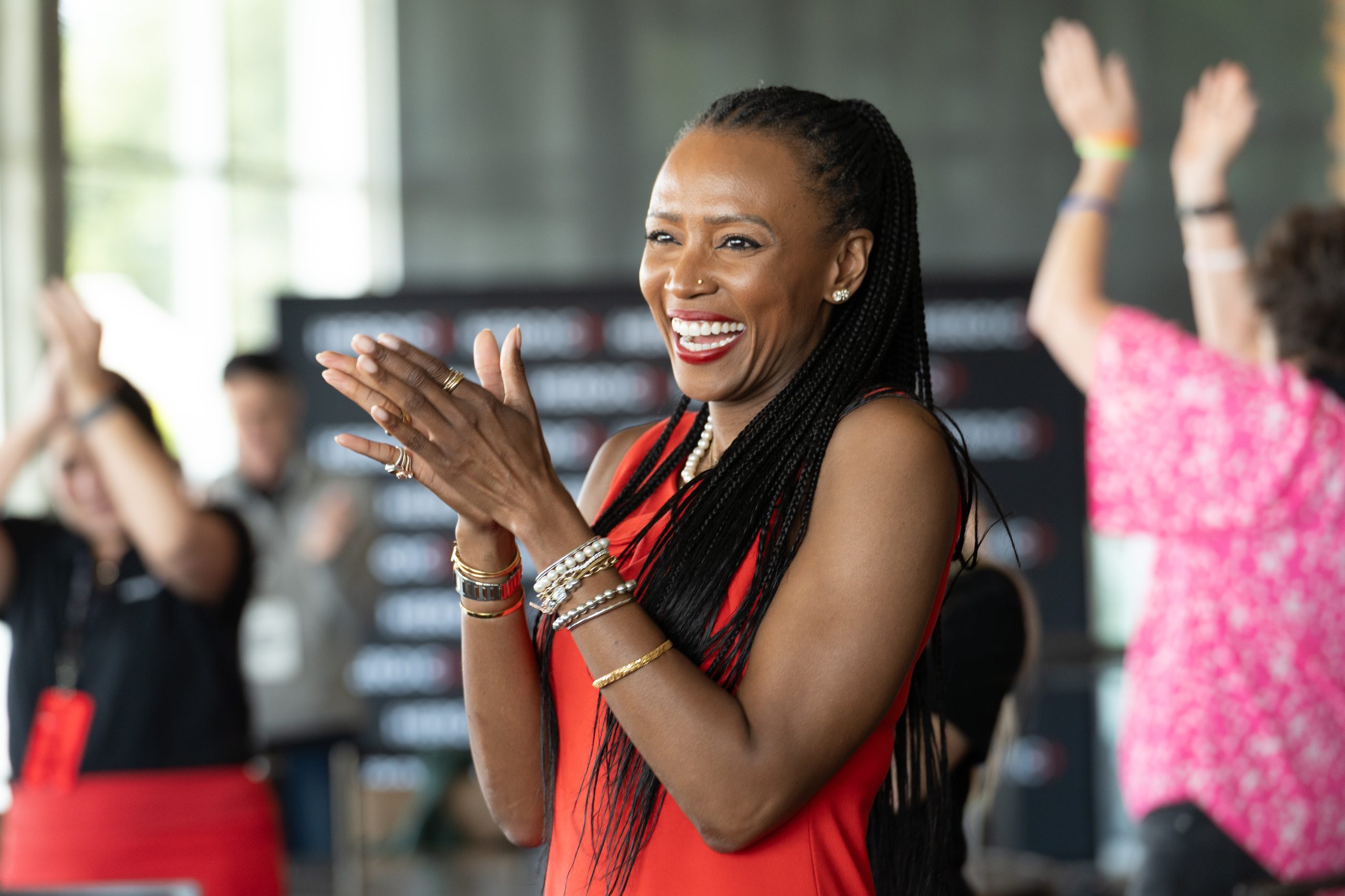 A member clapping and beaming during a morning session at a Heroic event