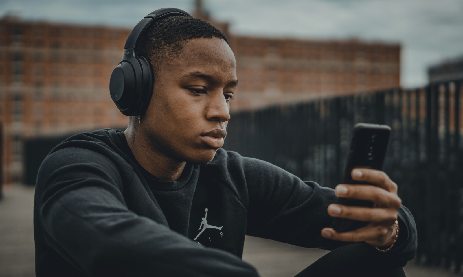 A member listening to a Philosopher's Note on his phone